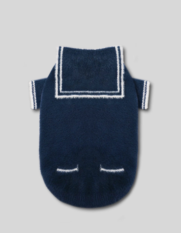 Close-up of the navy blue sailor cardigan showing plush knit fabric and refined stitching.
