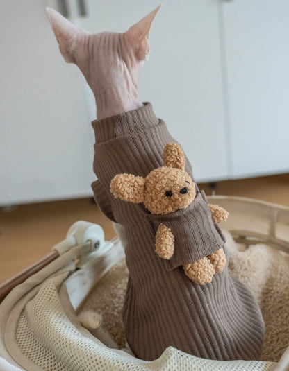 Devon Rex cat wearing a brown cotton sleeveless vest with an adorable bear detail, designed for lightweight warmth and comfortable everyday wear.