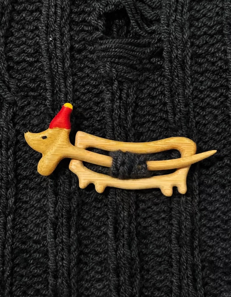 Handcrafted dachshund-shaped brooch for sweaters, featuring detailed enamel and gold-plated finish, perfect for dog lovers.