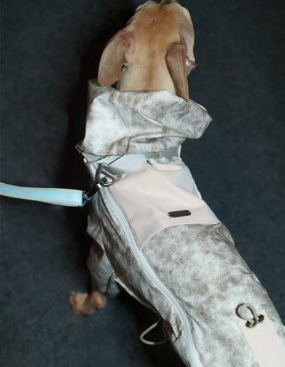 Back view of the CHISU TrailShield dog rain shell in Frosted Khaki showing protective outdoor coverage.