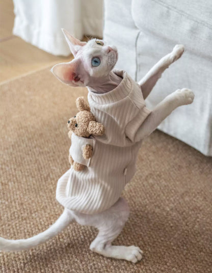 Devon Rex cat wearing a soft ivory cotton warm vest for autumn and winter.
