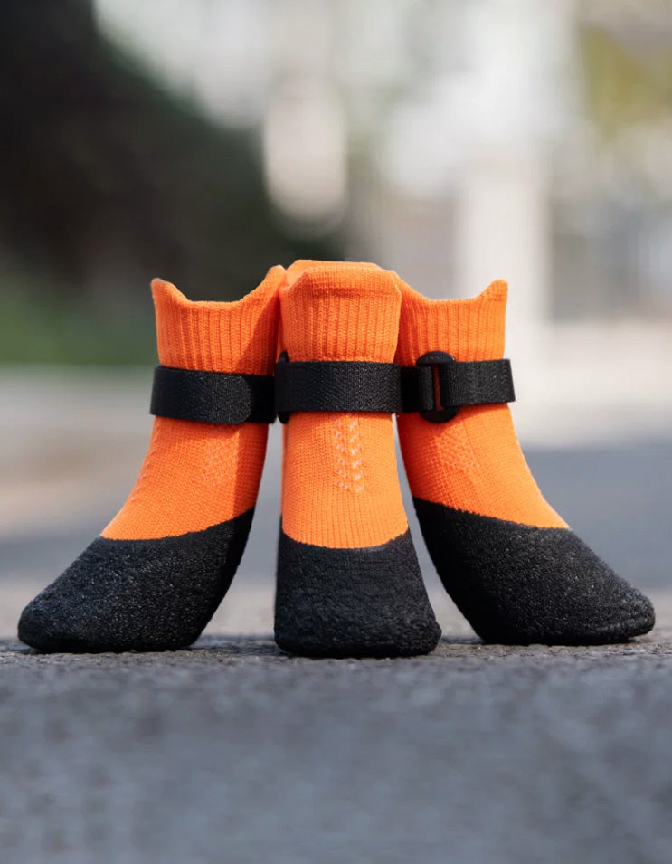 Orange dog boots featuring wrinkle-textured natural latex sole for enhanced grip