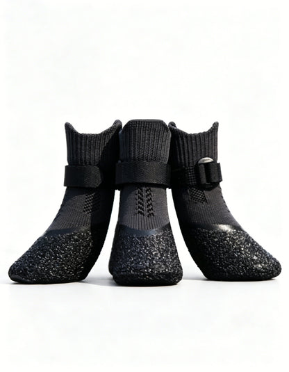 Black anti-slip dog boots with segmented strap system and natural latex sole