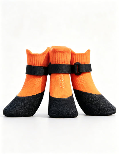 Orange outdoor dog boots designed for paw protection, traction and daily adventures