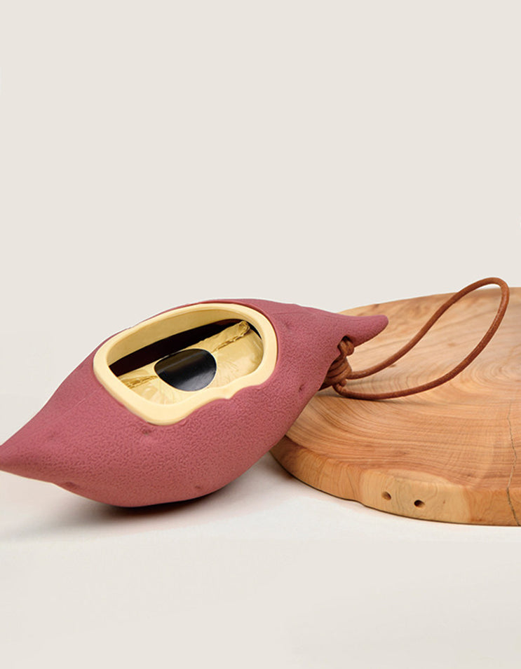Close-up view of the CHISU SweetSpud dog waste bag holder made from durable silicone with a realistic sweet potato design.