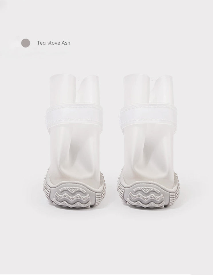 Tea-stove Ash waterproof dog boots with flexible fit and anti-slip tire pattern soles designed for rainy outdoor adventures.