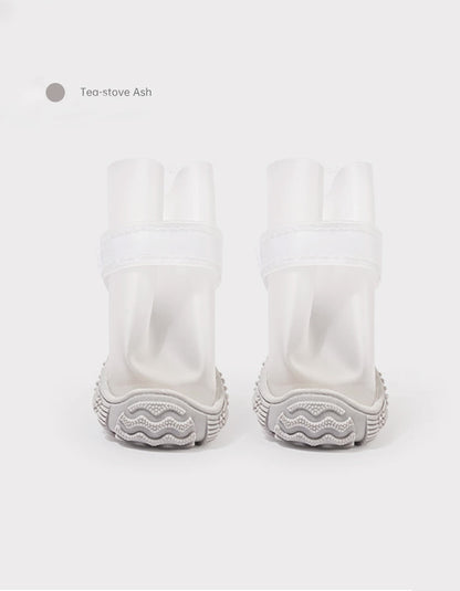 Tea-stove Ash waterproof dog boots with flexible fit and anti-slip tire pattern soles designed for rainy outdoor adventures.