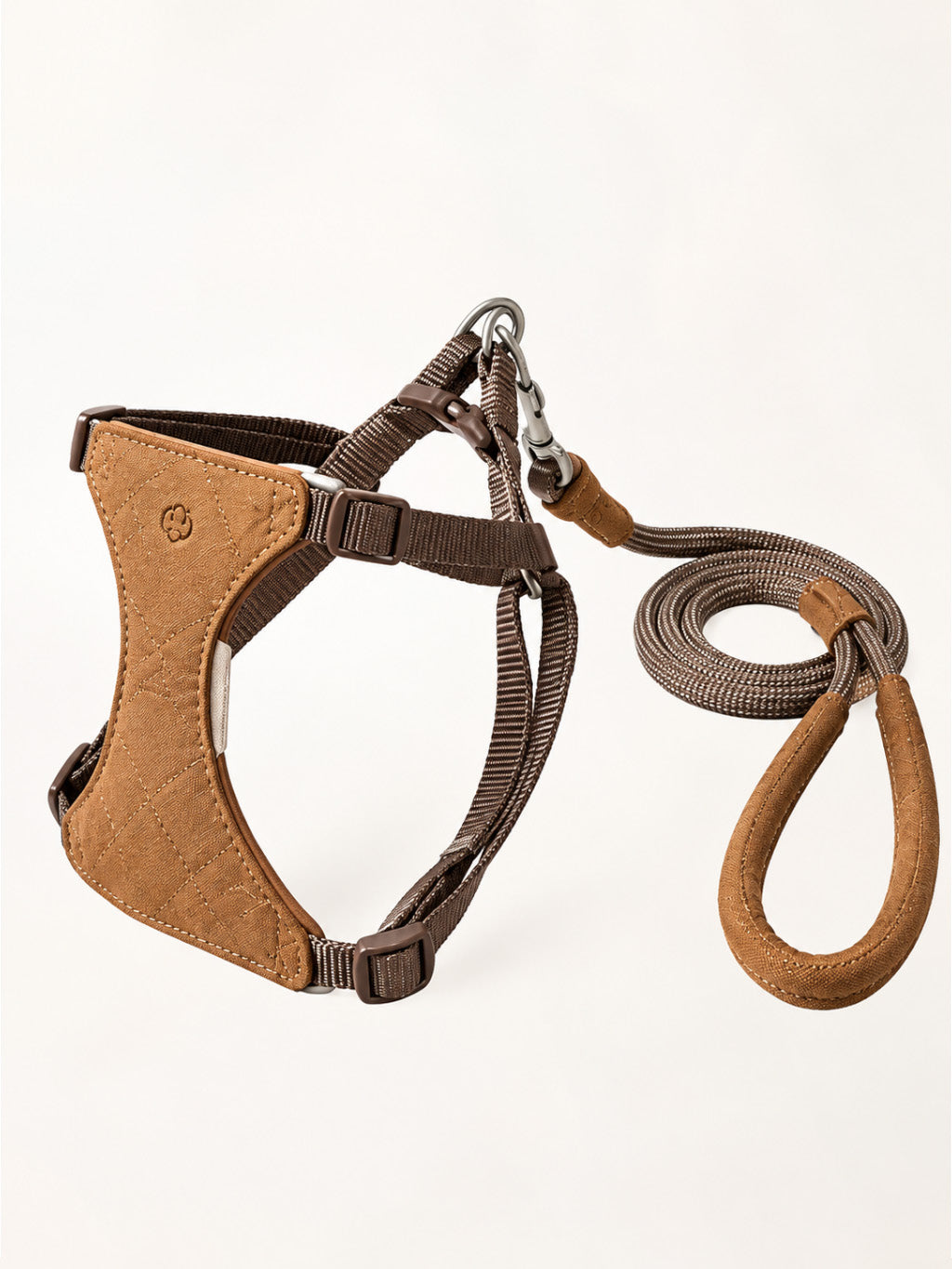 Close-up of the VivaBone suede cat harness showing its soft suede texture, adjustable nylon straps, secure metal D-ring, and anti-tangle swivel clasp.